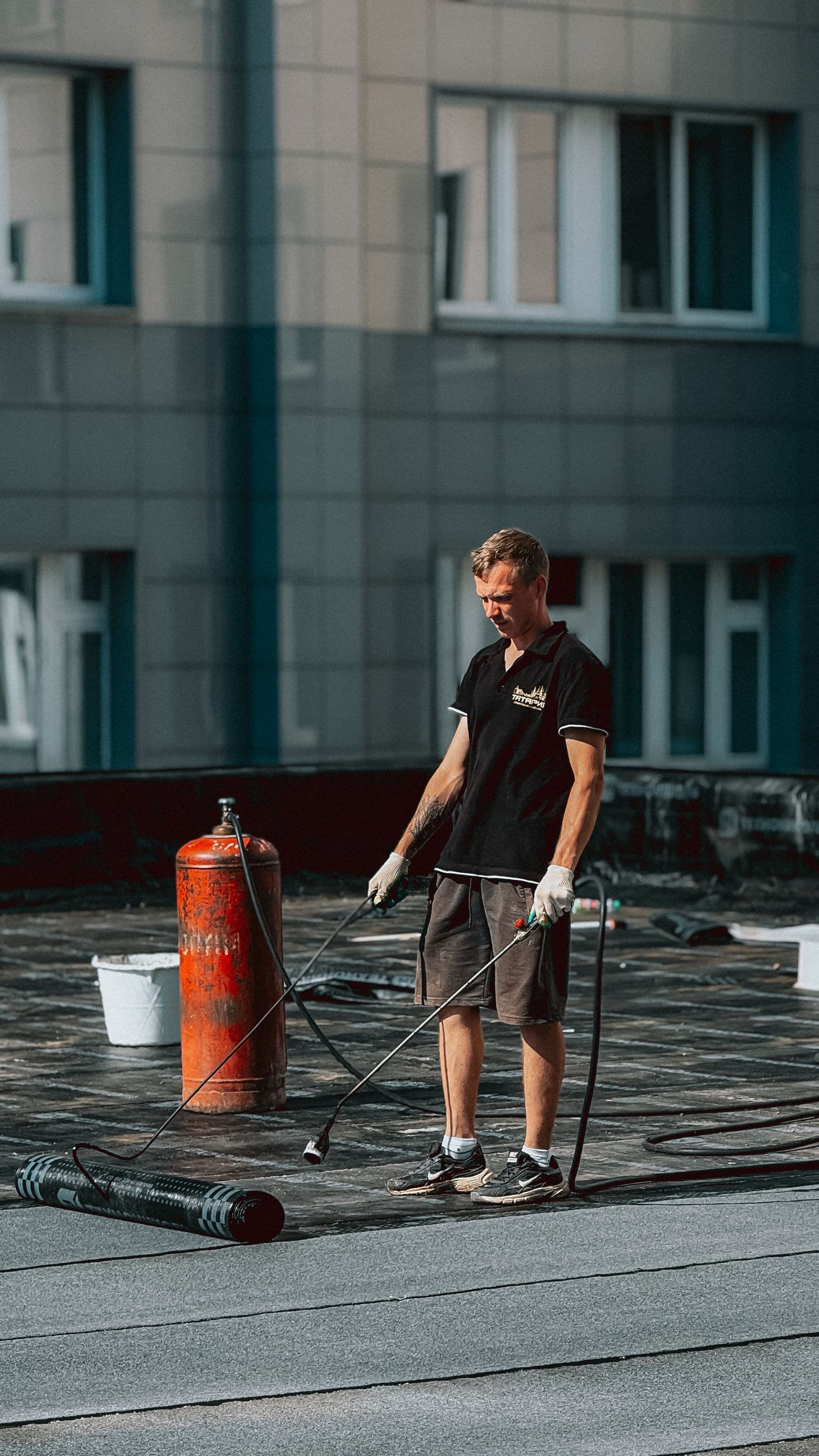 Roofer applying a membrane to a flat roof