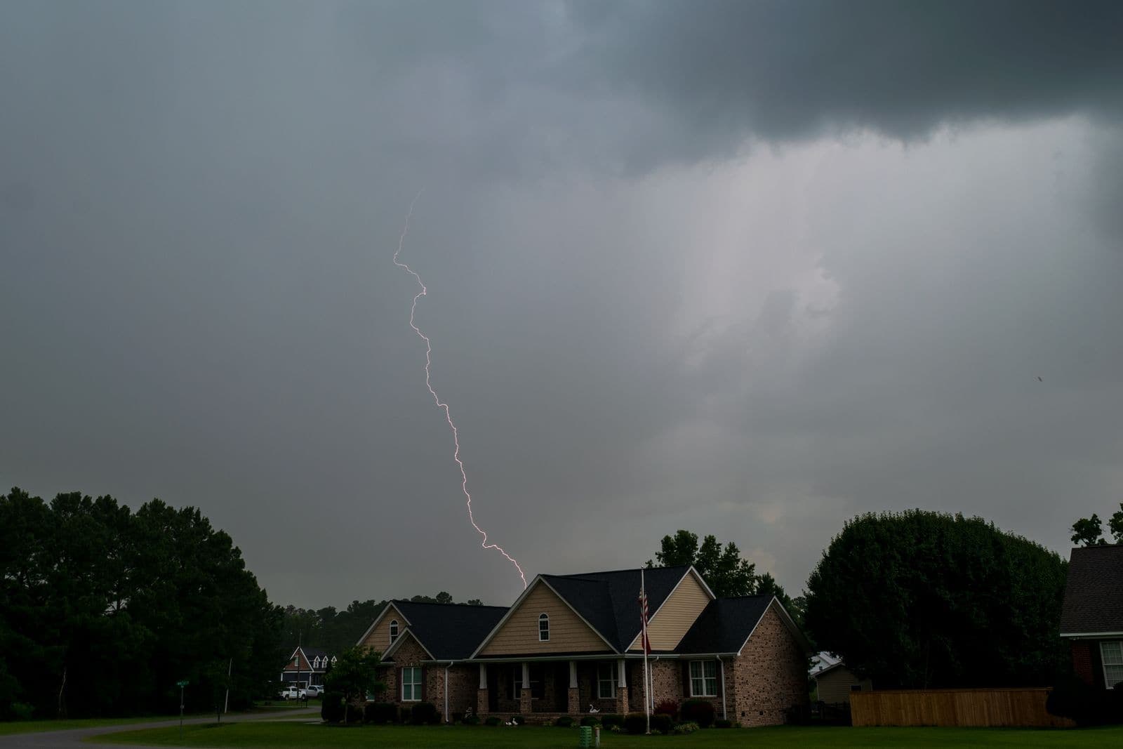 Lightning over a row of homes during a storm