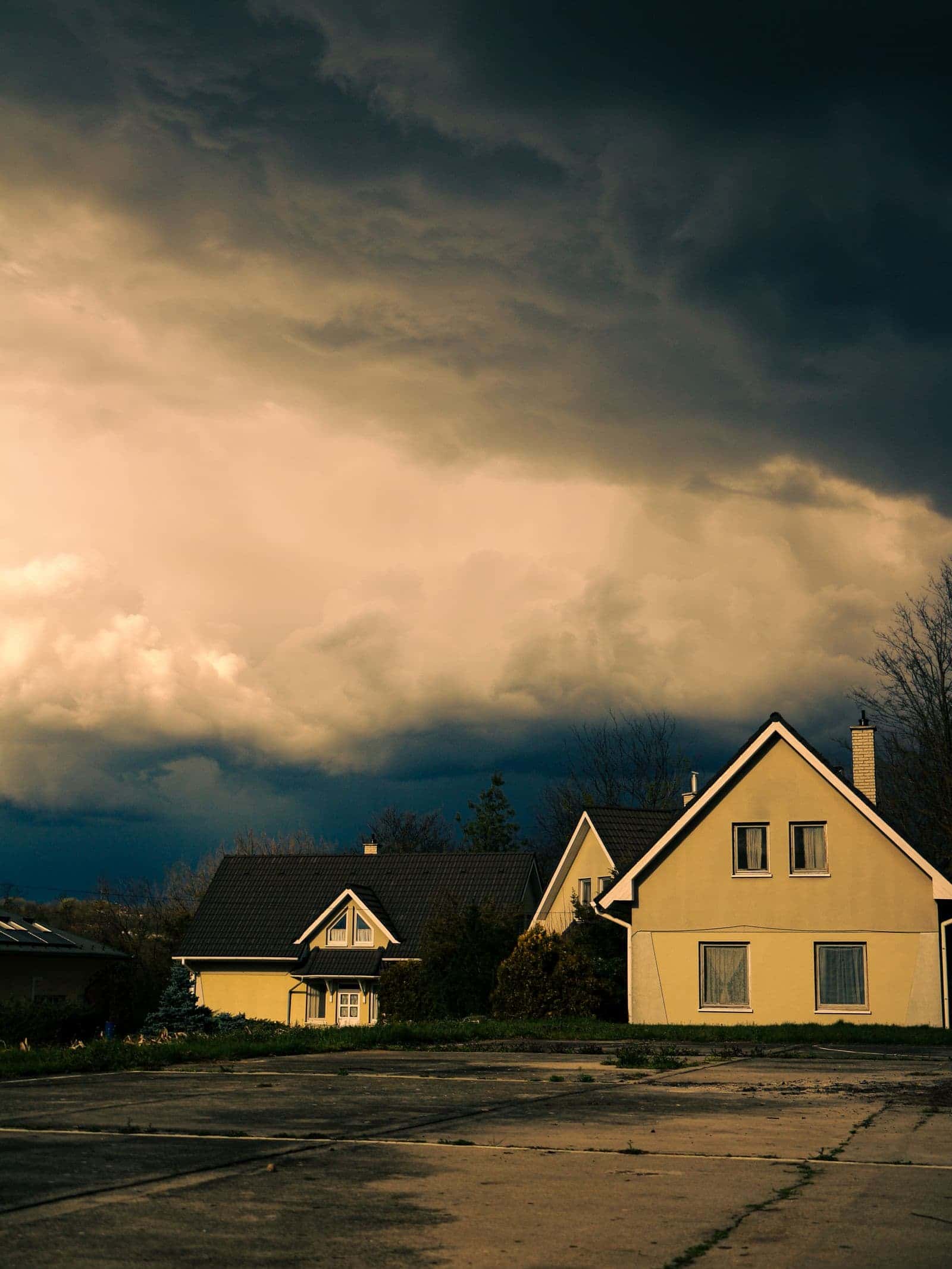 Storm clouds building over houses
